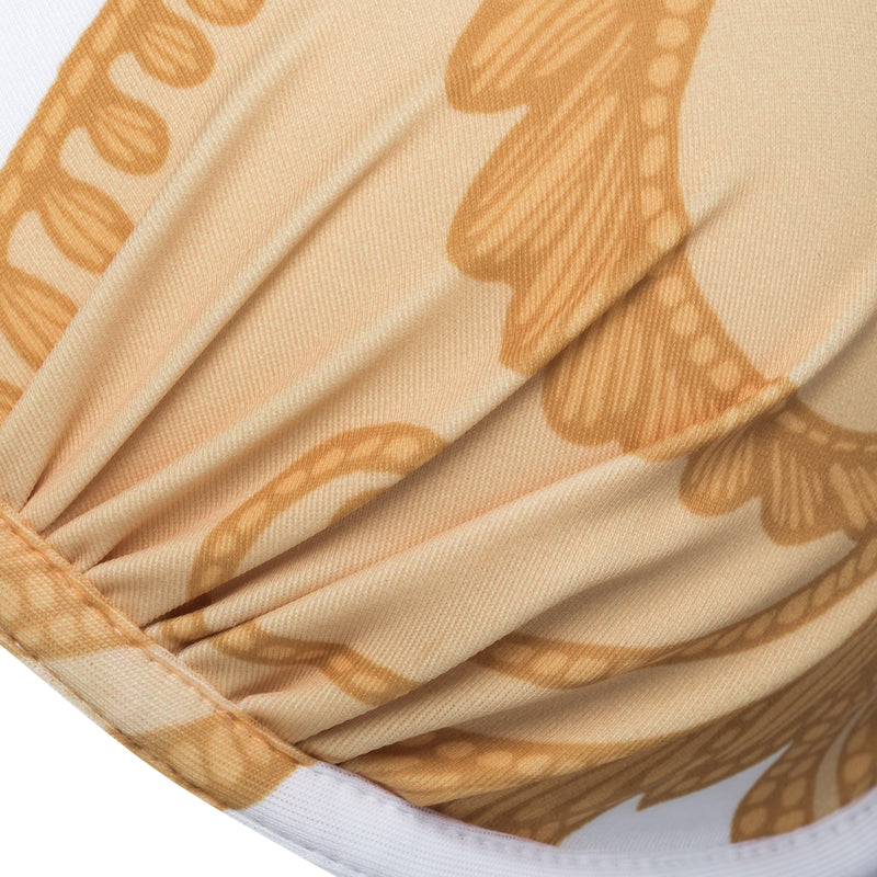 detail of a push-up bikini top in a yellow paisley print