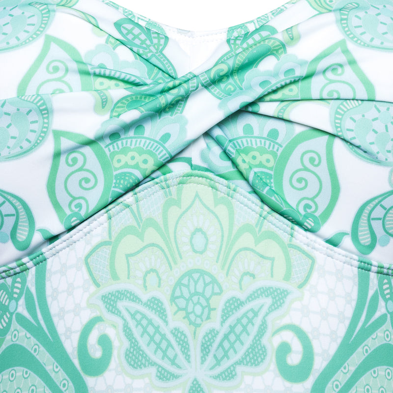 detail of a one-piece strapless swimsuit in emerald print