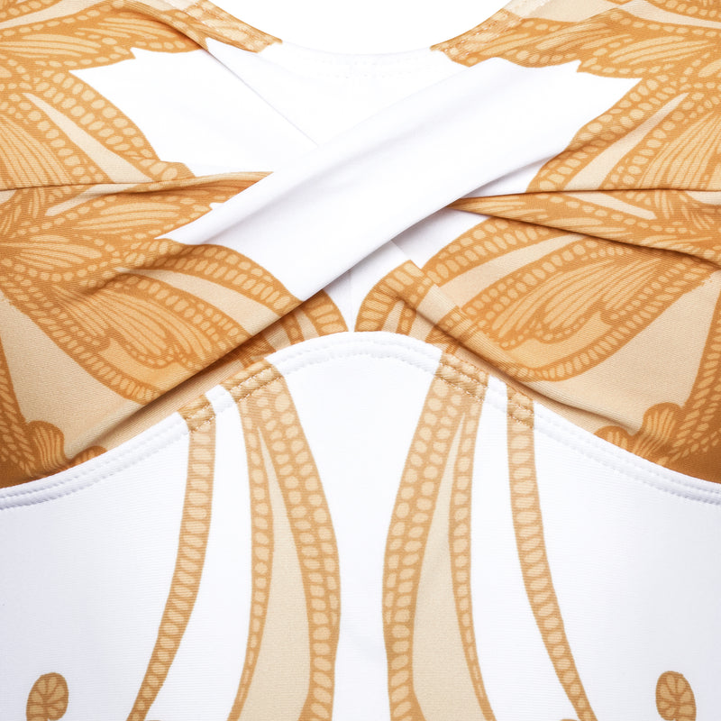 detail of a one-piece strapless swimsuit in a yellow paisley print
